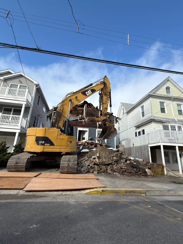 CAT 321D excavator demolishing a coastal property in Atlantic City — a SJ Hauck Construction site clearance and redevelopment project